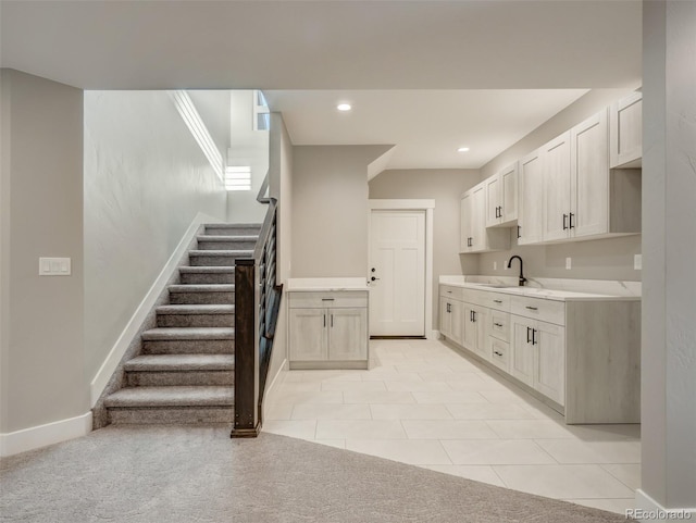 kitchen with white cabinetry, sink, and light tile patterned floors