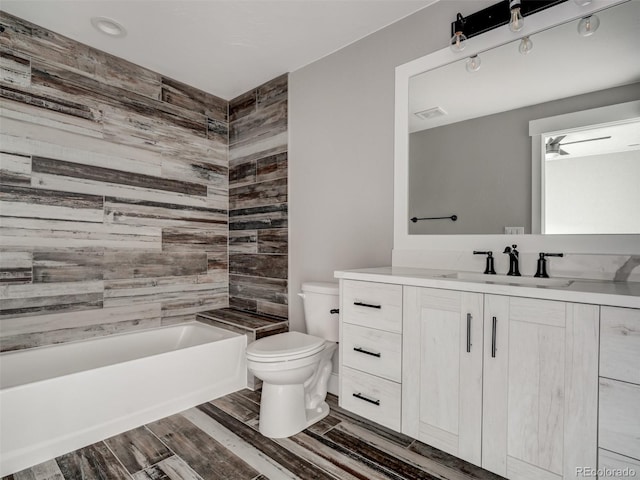 full bathroom with vanity, toilet, and tiled shower / bath combo