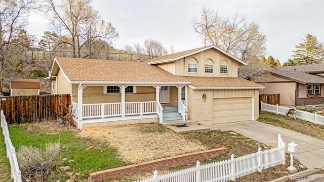 2706 Penacho Cir, Colorado Springs, CO 80917 - view of front of property with covered porch, driveway, a garage, and roof with shingles