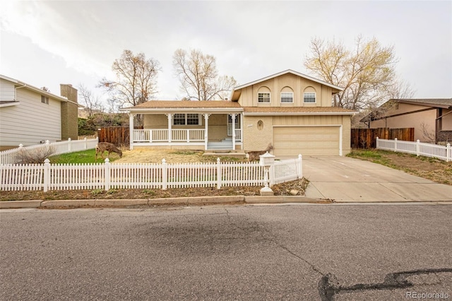 2706 Penacho Cir, Colorado Springs, CO 80917 - tri-level home featuring covered porch, a fenced front yard, a garage, and driveway