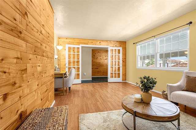 2706 Penacho Cir, Colorado Springs, CO 80917 - living area featuring wood walls, wood finished floors, and baseboards