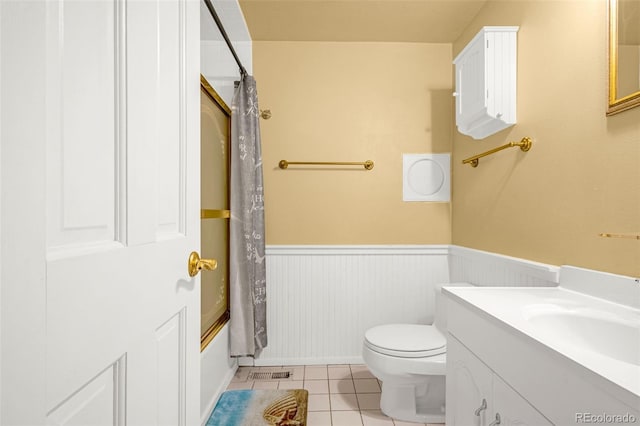 2706 Penacho Cir, Colorado Springs, CO 80917 - full bathroom featuring a wainscoted wall, tile patterned flooring, vanity, toilet, and shower / bathtub combination with curtain
