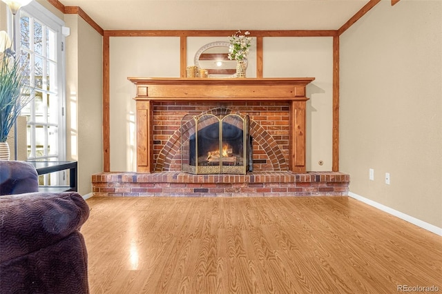 2706 Penacho Cir, Colorado Springs, CO 80917 - living area with wood finished floors, baseboards, and a brick fireplace