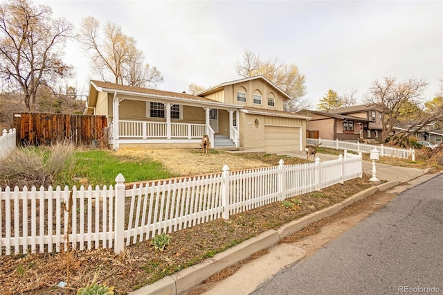 2706 Penacho Cir, Colorado Springs, CO 80917 - view of front of property featuring covered porch, a garage, and concrete driveway