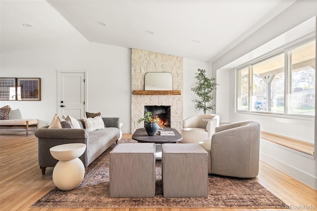13416 W 22nd Pl, Golden, CO 80401 - living area featuring baseboards, vaulted ceiling, wood finished floors, and a fireplace
