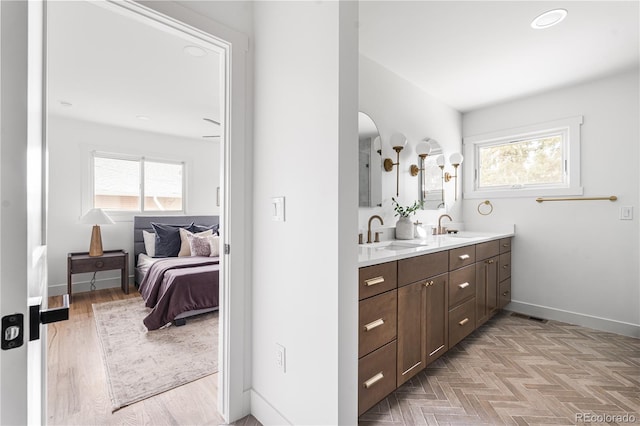 13416 W 22nd Pl, Golden, CO 80401 - bathroom featuring double vanity, a sink, and a wealth of natural light