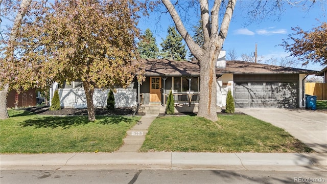 13416 W 22nd Pl, Golden, CO 80401 - view of front of home with an attached garage, a front lawn, fence, and concrete driveway