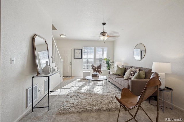 carpeted living room featuring ceiling fan