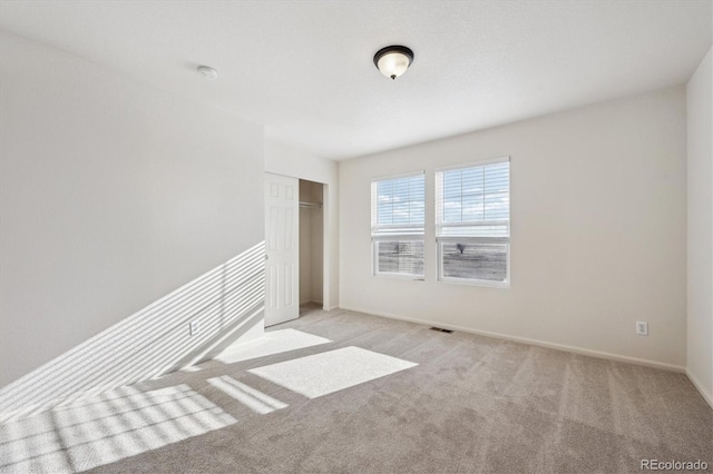 spare room featuring light colored carpet