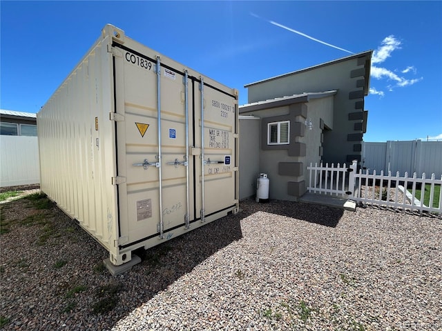 view of outbuilding featuring fence
