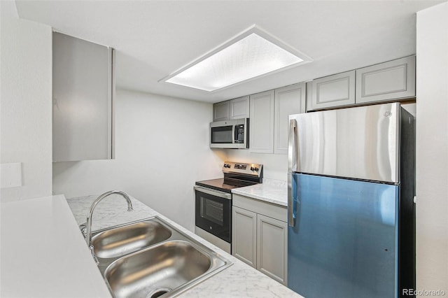 17094 E Tennessee Dr Unit 212, Aurora, CO 80017 - kitchen with appliances with stainless steel finishes, gray cabinets, a sink, and light countertops