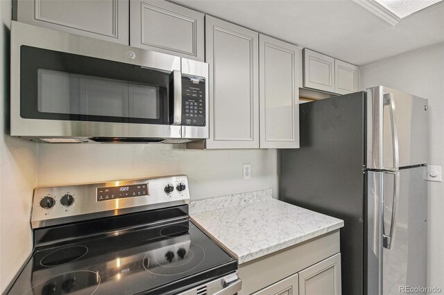 17094 E Tennessee Dr Unit 212, Aurora, CO 80017 - kitchen featuring appliances with stainless steel finishes and light stone countertops