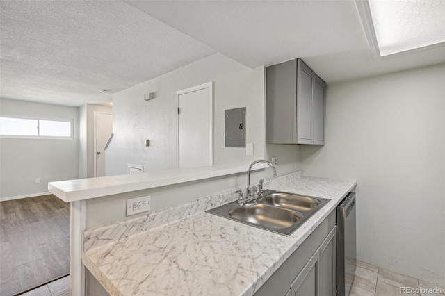 17094 E Tennessee Dr Unit 212, Aurora, CO 80017 - kitchen with a sink, gray cabinetry, electric panel, light countertops, and a textured ceiling