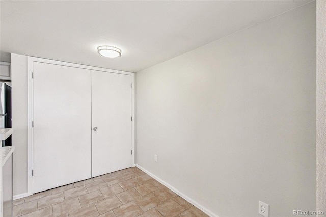 17094 E Tennessee Dr Unit 212, Aurora, CO 80017 - unfurnished bedroom with baseboards and a closet