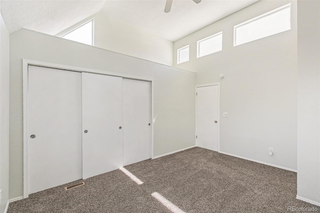 17094 E Tennessee Dr Unit 212, Aurora, CO 80017 - unfurnished bedroom featuring carpet floors, a closet, a ceiling fan, and a towering ceiling
