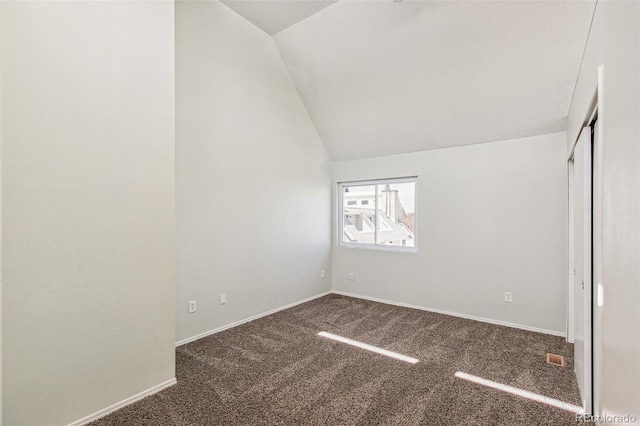 17094 E Tennessee Dr Unit 212, Aurora, CO 80017 - unfurnished bedroom with vaulted ceiling, carpet floors, and baseboards
