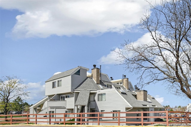 17094 E Tennessee Dr Unit 212, Aurora, CO 80017 - back of property featuring roof with shingles and a chimney