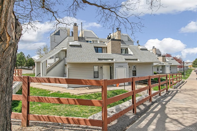 17094 E Tennessee Dr Unit 212, Aurora, CO 80017 - back of property with a chimney and roof with shingles