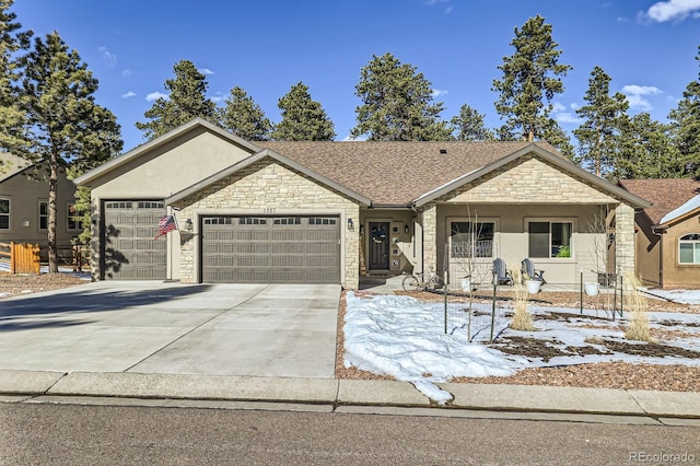 ranch-style house with roof with shingles, stucco siding, concrete driveway, an attached garage, and stone siding