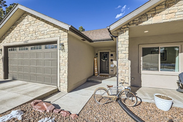 property entrance with an attached garage, stone siding, driveway, roof with shingles, and stucco siding