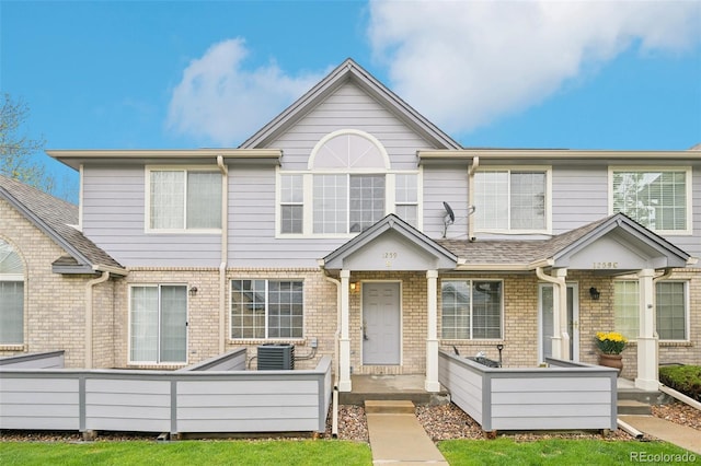 townhome / multi-family property with brick siding