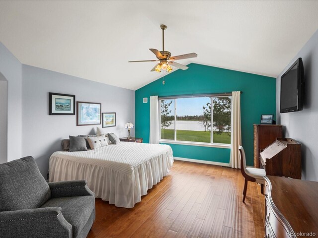 bedroom featuring a ceiling fan, lofted ceiling, and wood finished floors