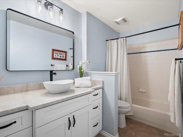 bathroom with visible vents, tile patterned floors, vanity, toilet, and shower / bath combo with shower curtain