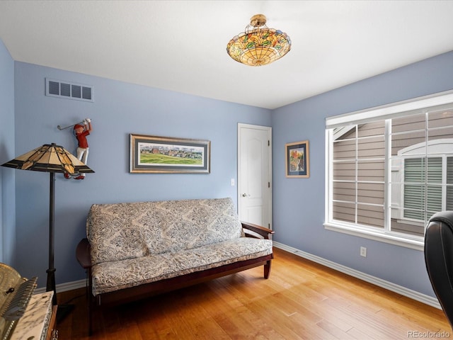 sitting room featuring baseboards, wood finished floors, and visible vents