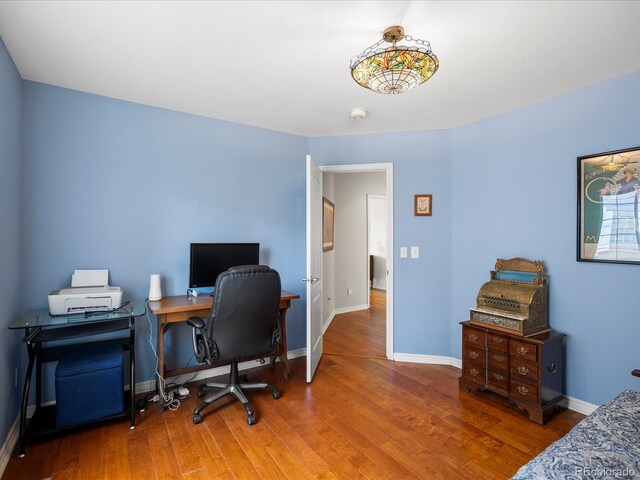 office with baseboards and wood finished floors