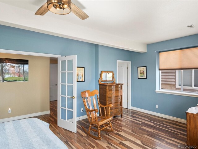 bedroom featuring visible vents, wood finished floors, baseboards, multiple windows, and french doors