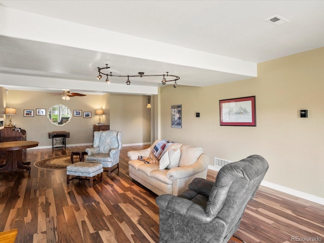 living area with baseboards, ceiling fan, wood finished floors, and visible vents
