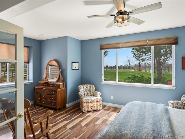 bedroom with baseboards, ceiling fan, and wood finished floors