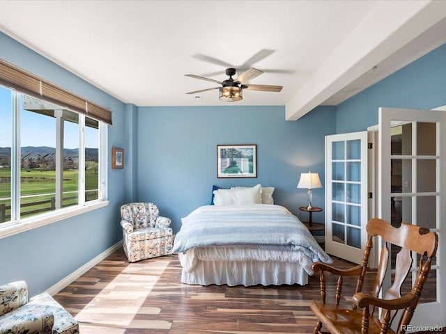 bedroom featuring baseboards, a ceiling fan, and wood finished floors