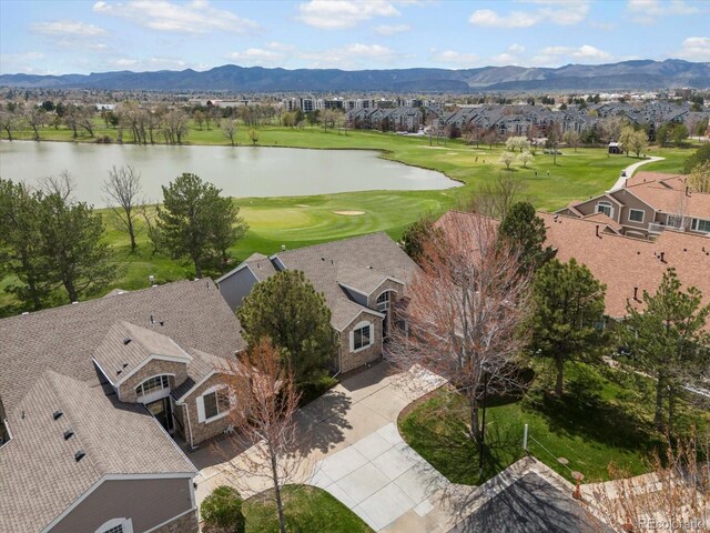 birds eye view of property featuring view of golf course, a residential view, and a water and mountain view