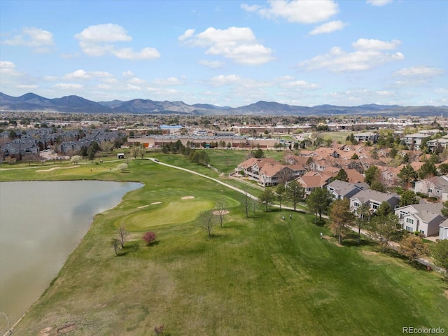 aerial view featuring a water and mountain view, view of golf course, and a residential view