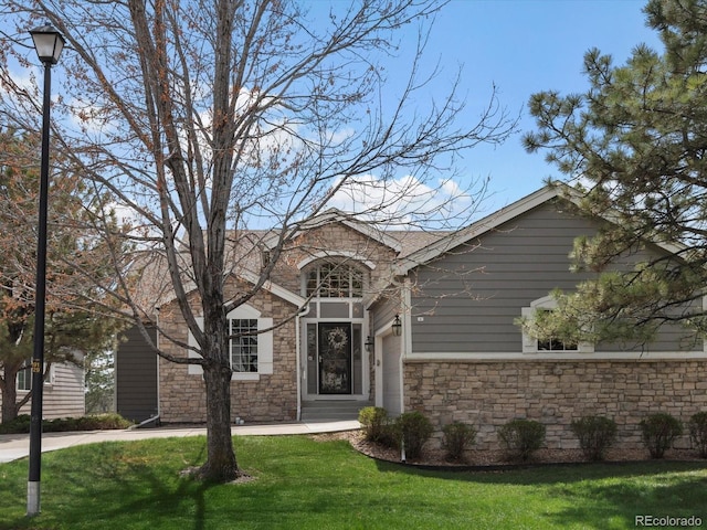 view of front of house featuring a front yard and stone siding