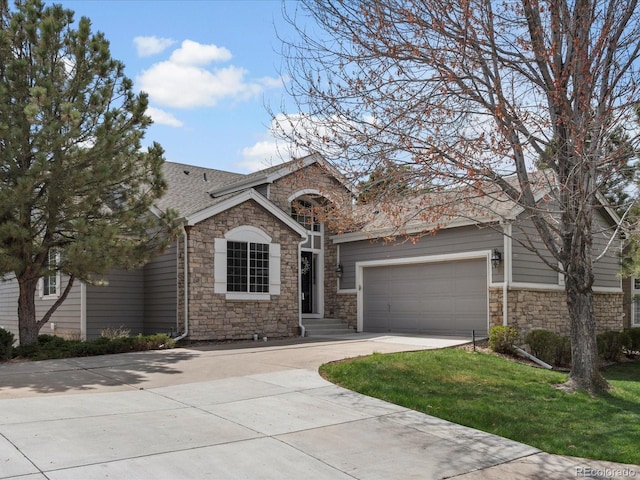 ranch-style house with a shingled roof, a front lawn, stone siding, a garage, and driveway