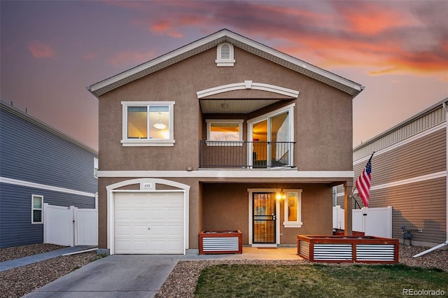 4705 Andes St, Denver, CO 80249 - view of front of home with a balcony, stucco siding, fence, driveway, and a garage