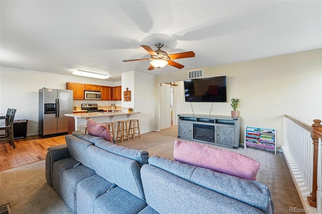 4705 Andes St, Denver, CO 80249 - living area with a ceiling fan, baseboards, and light wood-type flooring