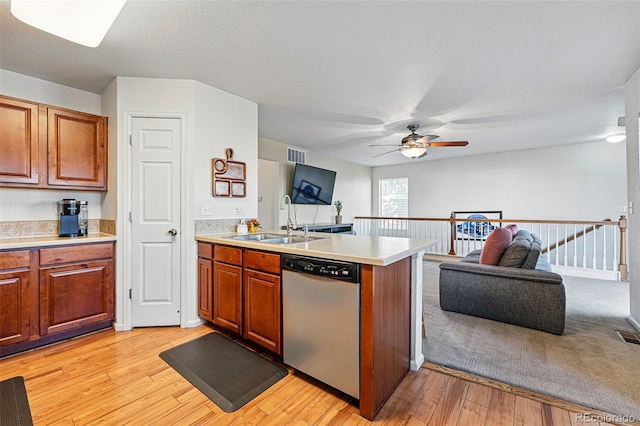 4705 Andes St, Denver, CO 80249 - kitchen with stainless steel dishwasher, a sink, open floor plan, and a peninsula