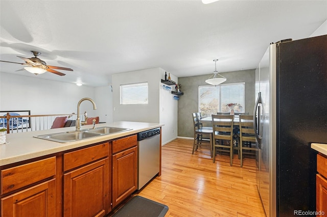 4705 Andes St, Denver, CO 80249 - kitchen with stainless steel appliances, a sink, light countertops, and plenty of natural light