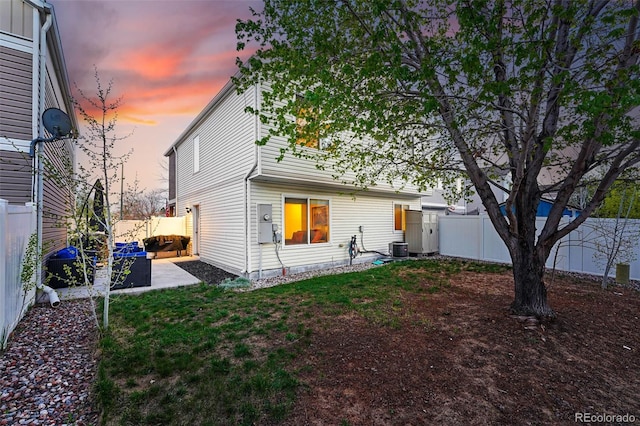 4705 Andes St, Denver, CO 80249 - back of property at dusk featuring central air condition unit and a patio area