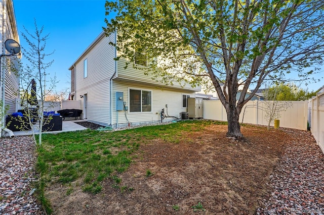4705 Andes St, Denver, CO 80249 - back of property with a fenced backyard, central air condition unit, and a patio