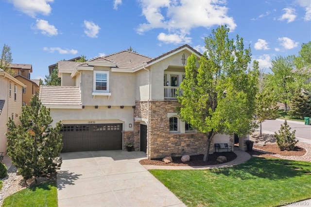view of front of property with a balcony, stone siding, concrete driveway, and stucco siding