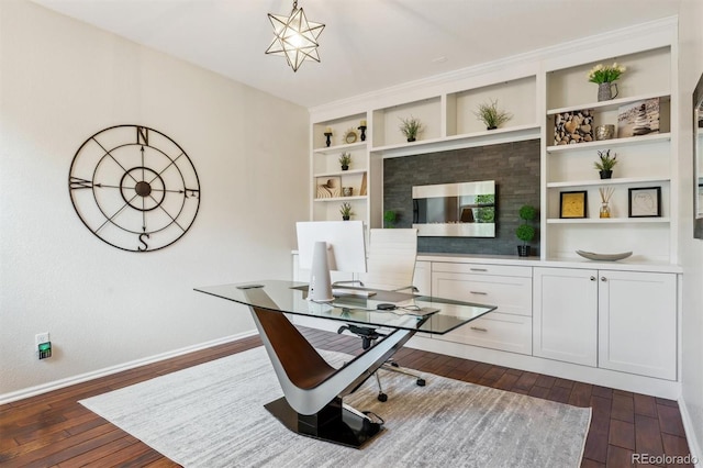 office with dark wood-type flooring, baseboards, and built in features