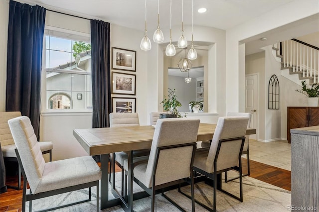 dining area featuring stairway, wood finished floors, and baseboards