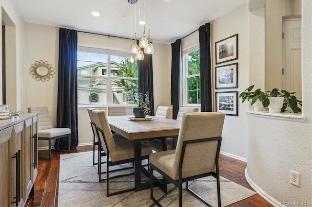 dining room featuring healthy amount of natural light, dark wood-type flooring, baseboards, and recessed lighting