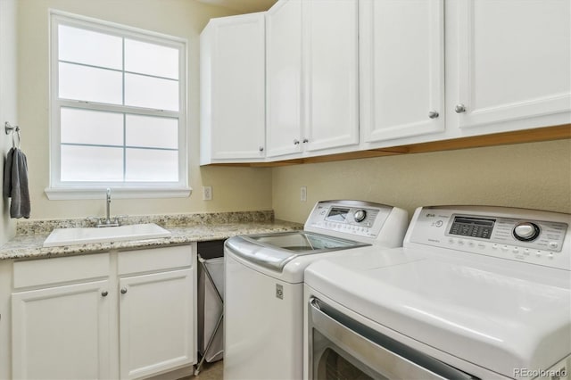 laundry area with washer and clothes dryer and cabinet space