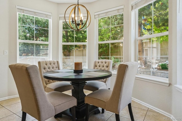 dining room featuring a chandelier, baseboards, and light tile patterned flooring