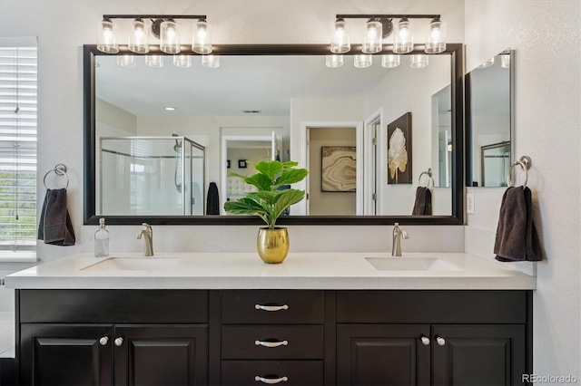 bathroom featuring a stall shower and double vanity
